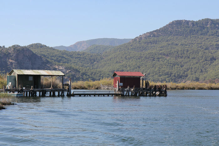 Der er fiskeopdræt i Dalyan floden. For at fiskene ikke skal svømme ud i havet, er der lavet en sluse, som bådene skal igennem. Nettet mellem husene sænkes, når bådene passerer.