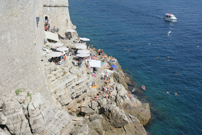 Der er et par udgange ud mod vandet i muren rundt om Dubrovnik. Ved en af udgangene ligger Buza beach bar, hvor man også bader fra.