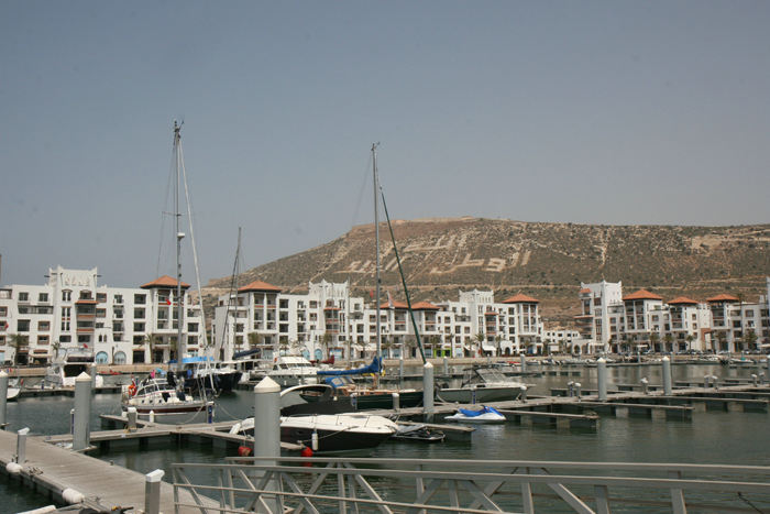 Marinaen i Agadir. Oppe på toppen af bjerget (236 m) ligger Kasbah’en, som et vartegn for byen. På bjergsiden står der skrevet i hvide sten: ”Gud, Fædrelandet og Kongen”.